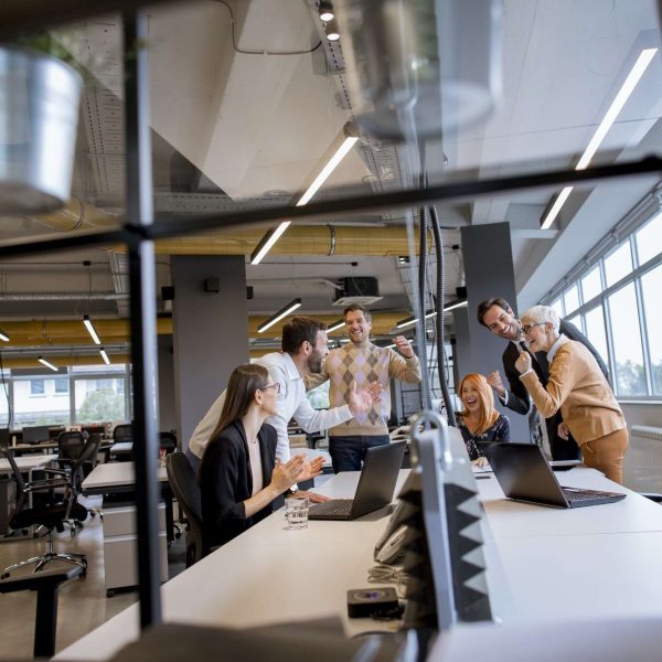 happy-young-business-people-standing-in-the-office-and-looking-forward-to-success-in-the-office (1)